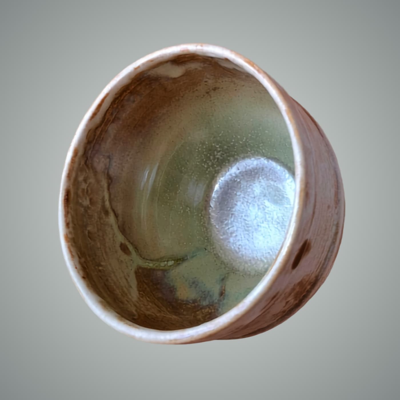 Handmade stoneware bowl with four mixed glazes and iron oxide. Celadon green and warm earth interior. Wheel-thrown, one of a kind by ceramist Przemysław Gołębiewski, Berlin.